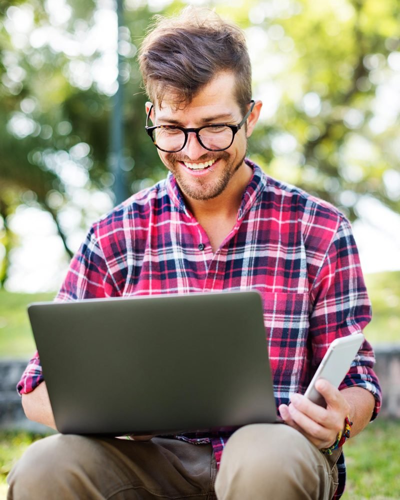young man smartphone browsing laptop concept pl96pn7.jpg